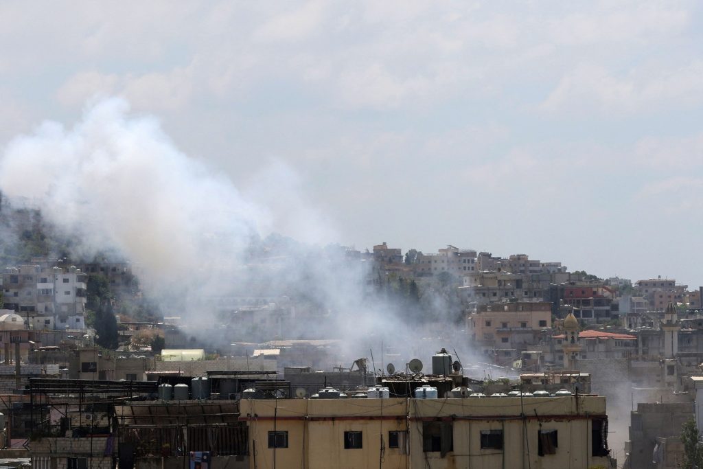 Smoke billows during clashes between Fatah movement and Islamists inside the Ain al-Helweh Palestinian refugee camp, Lebanon's largest Palestinian refugee camp, in the southern coastal city of Sidon on July 30, 2023. (Photo by Mahmoud ZAYYAT / AFP)